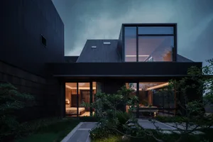 A modern residential house exterior captured during twilight.