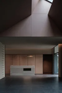 An image of a modern industrial lobby with a reception desk on a polished floor.