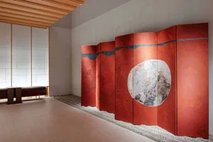 Red room divider with textured circular pattern