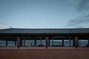 The image depicts the exterior roofline of a traditional building with a terrazzo roof.