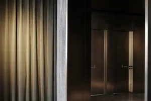 A modern interior design featuring metallic surfaces and minimalist style.