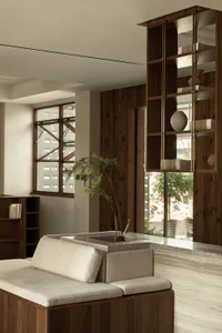 A minimalist residential interior featuring wood and marble elements.