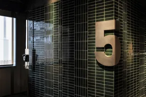 Modern building with black tiles featuring number 5.