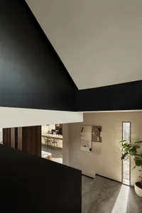 A modern residential entryway featuring white concrete walls and minimalist design elements.