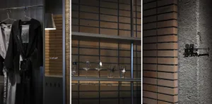 Modern interior design featuring brick shelving with wine glasses and a metal lamp.