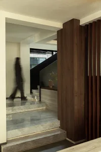 Modern interior design featuring marble stairs and wooden elements.
