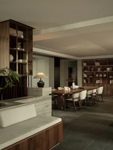 A modern restaurant interior featuring wooden furnishings and contemporary design elements.