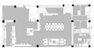 A detailed 2D architectural plan of a modern office space, featuring a central workspace area with desks, chairs, and multipl