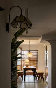 A modern dining room features wooden furniture with sleek, minimalist designs.