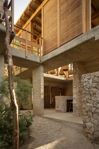 Modern residential space featuring stone, concrete, and wood materials.