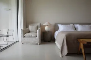Minimalist bedroom featuring neutral-toned textiles and furniture