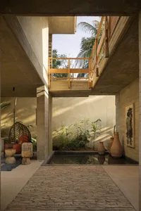 A minimalist interior space with a concrete path leading to a small courtyard.