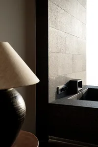 A minimalist interior space featuring granite surfaces and metallic elements.