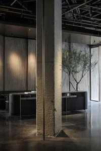 Modern office with concrete walls and metal accents.