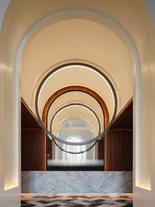 Modern entrance with marble and concrete materials and a circular design element.
