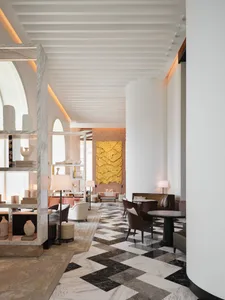Modern hotel lobby featuring marble flooring and walls.