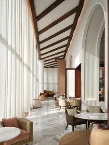 Image of a modern hotel lounge featuring glass, marble, and wood materials.