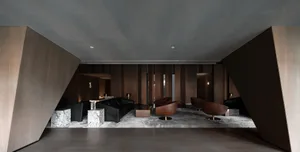 Industrial-style retail lobby with wooden walls and black and brown furniture.