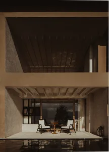 Minimalist outdoor terrace with concrete flooring and furniture.