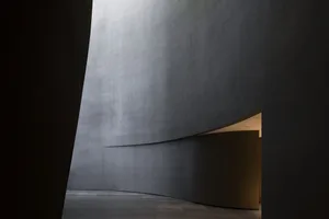 A modern lobby interior with concrete walls and floor.