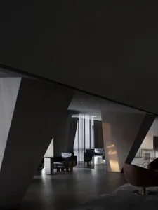 A modern lobby with dark wood finishes and minimalist design elements.