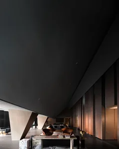A modern lobby with metallic walls and dark wood accents.