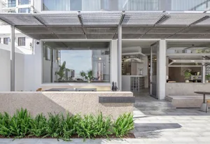 Modern restaurant exterior designed with concrete, glass, and steel elements.