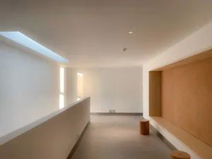 Modern architectural interior featuring a concrete corridor with minimalist design elements