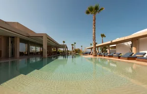 Modern poolside lounge area with concrete materials.