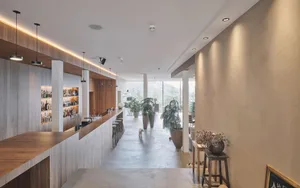 A modern commercial space featuring concrete, wood, and glass materials.