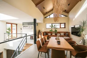 Modern residential living space featuring a concrete floor and wooden furniture with a warm and inviting atmosphere.
