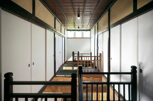 Modern wooden staircase with white walls and wooden railings.