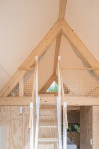 White mesh loft platform enclosed with wooden frame and steps