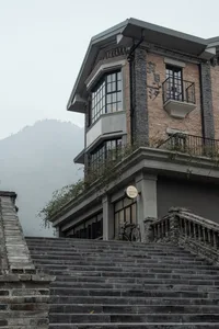 A stone staircase leading up to a brick building exterior with a glass coffee bar sign.