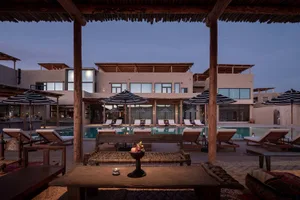 Luxurious residential interior featuring a poolside lounge area with sandstone construction.