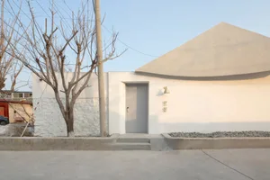 A minimalist entryway featuring a concrete door and wall with a sleek, modern design.