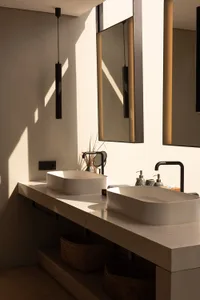 A modern bathroom featuring marble sinks and countertops.