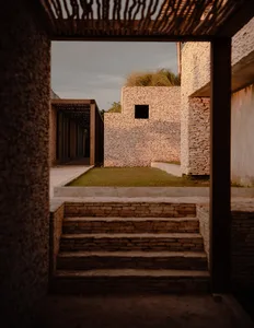 A modern garden with stone walls and a grass-covered roof