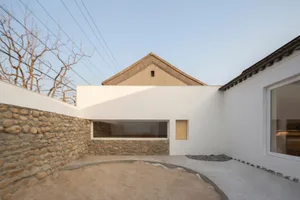 Contemporary modern house with white walls and concrete and stone terrace.