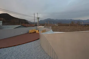 Modern outdoor space featuring brick patio and gravel surround