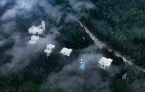 Modern residential buildings surrounded by clouds with concrete and glass materials