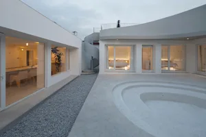 Modern residential building with concrete exterior and geometric design.