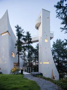 A modern residential house with concrete exterior and geometric design.