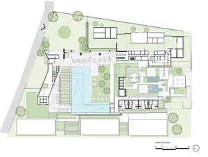 Floor plan of a residential compound featuring multiple buildings, green spaces, and outdoor amenities.