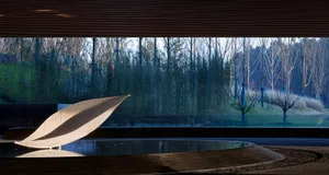 A modern architectural space featuring a water feature clad in ceramic material.