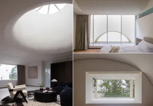 A modern bedroom featuring a large glass window, minimalist furniture, and a cozy ambiance.