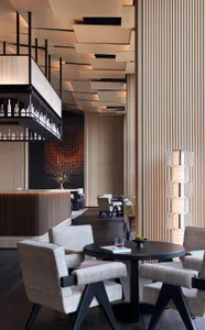 A modern restaurant bar featuring wooden design elements.