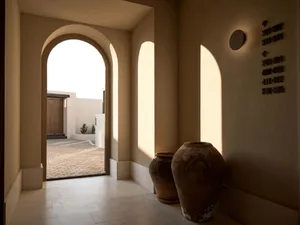 Concrete entrance hallway with large arches and rustic vases