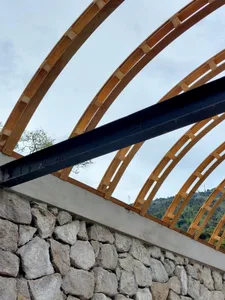 Wooden and metal roof trusses supporting a structure.