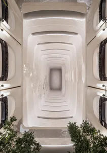 An elegant architectural interior with concrete walls and light fixtures.